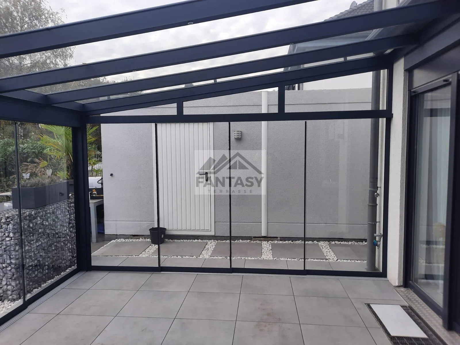 Terrassenüberdachung mit Glasschiebefenstern und Unterlicht